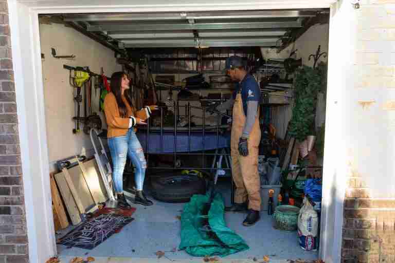 trash and stash in the garage with customer looking at items to store