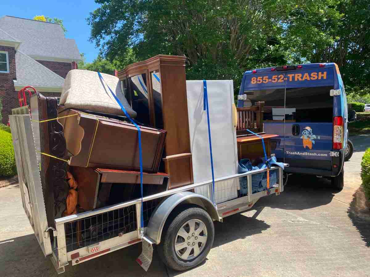 Junk Removal van with utility trailer full of furniture